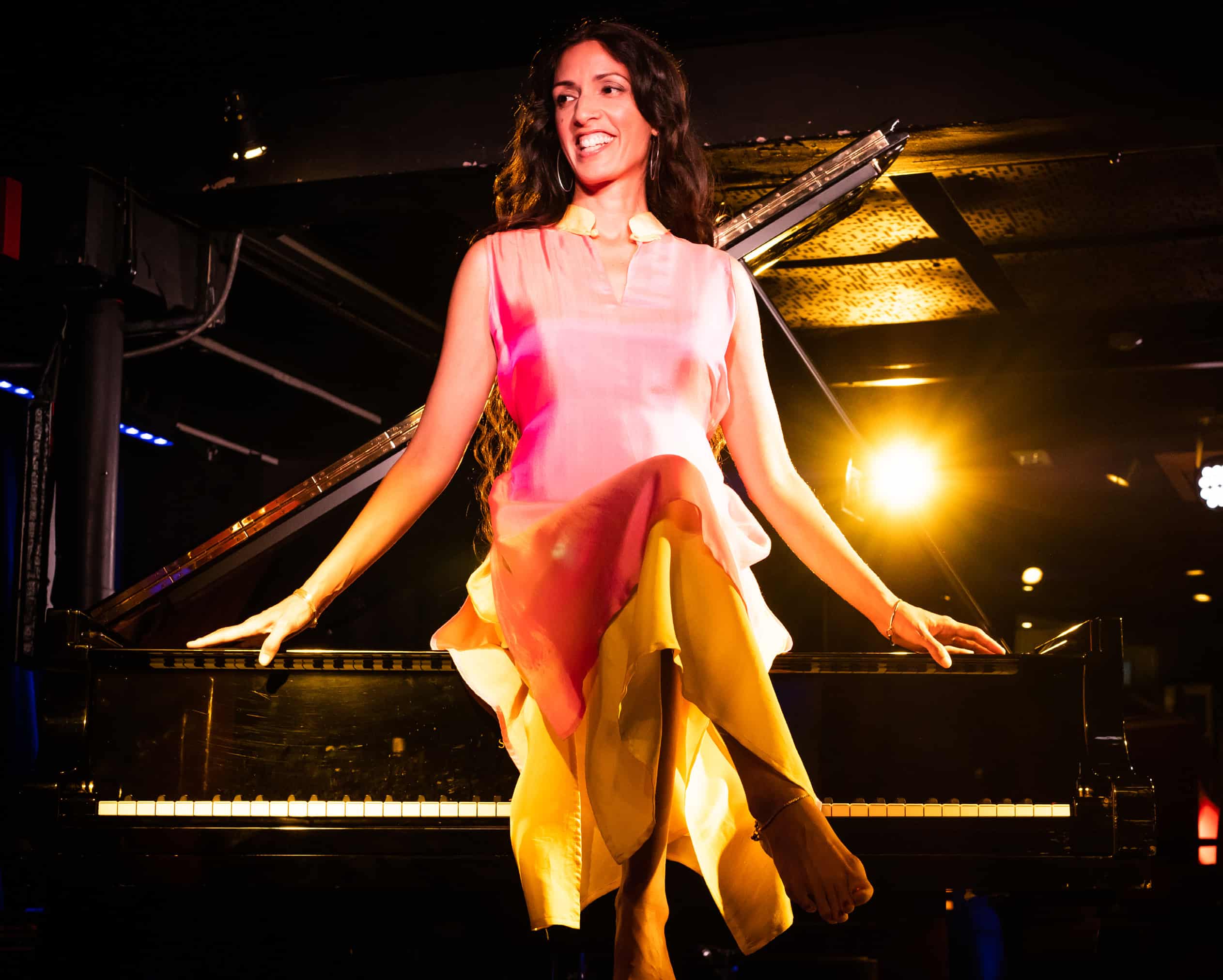 Zoe Rahman sat on a piano